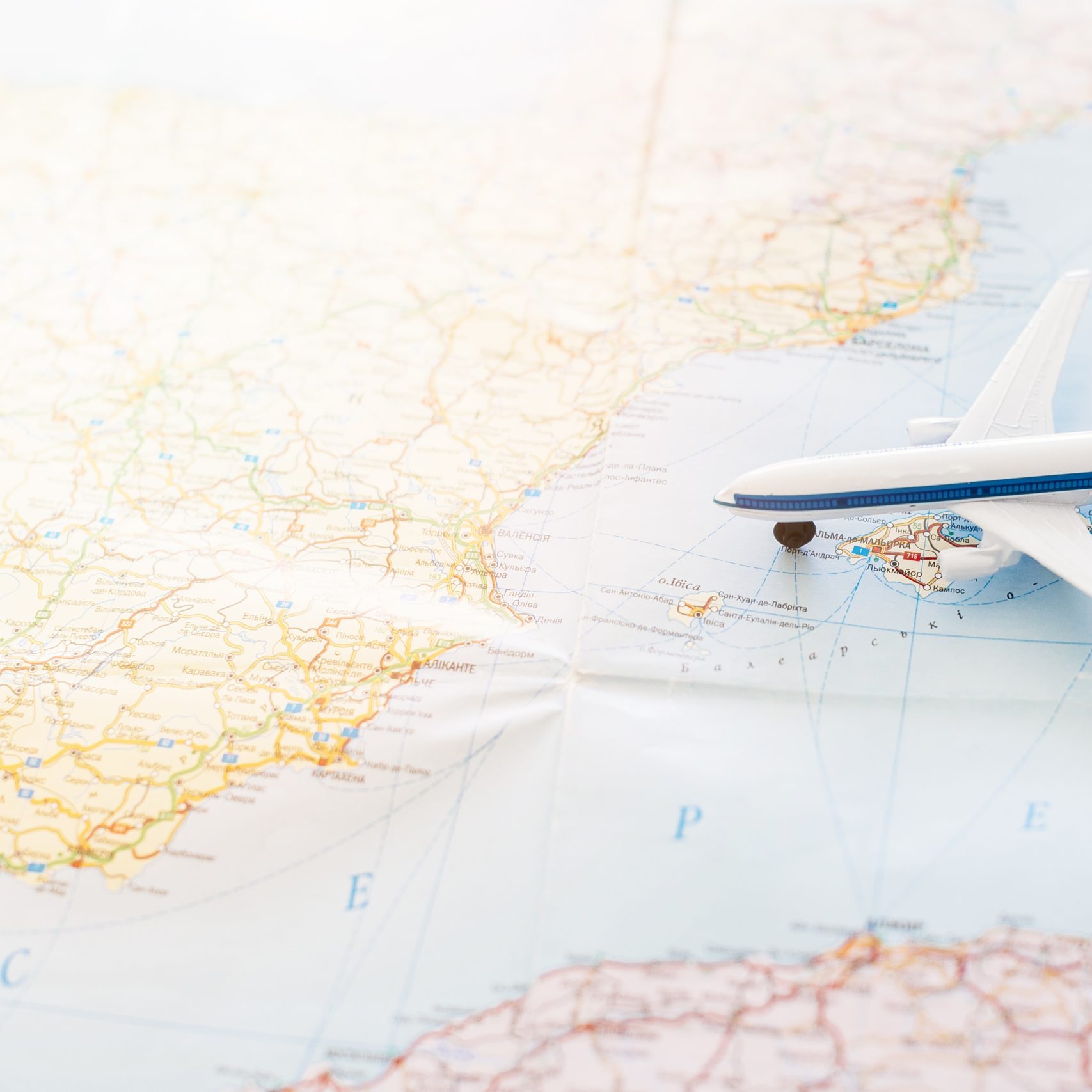 travel-background-with-toy-plane-map-scaled